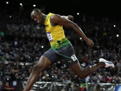 Jamaica's Usain Bolt crosses the finish line to win gold in the men's 100-meter final during the athletics in the Olympic Stadium at the 2012 Summer Olympics, London, Sunday, Aug. 5, 2012. (AP Photo/David J. Phillip)