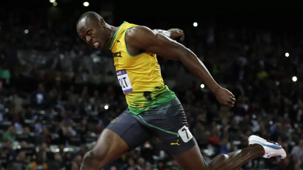 Jamaica's Usain Bolt crosses the finish line to win gold in the men's 100-meter final during the athletics in the Olympic Stadium at the 2012 Summer Olympics, London, Sunday, Aug. 5, 2012. (AP Photo/David J. Phillip)