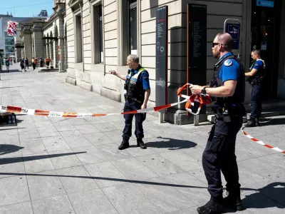 Police officers remove tape following a stabbing attack at the train station in Winterthur, Switzerland, Thursday, May 28, 2026. (Claudio Thoma/Keystone via AP)