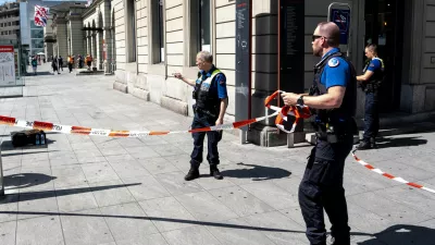 Police officers remove tape following a stabbing attack at the train station in Winterthur, Switzerland, Thursday, May 28, 2026. (Claudio Thoma/Keystone via AP)