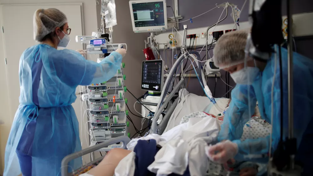 Medical staff members work in the Intensive Care Unit (ICU) where patients suffering from the coronavirus disease (COVID-19) are treated at the Melun-Senart hospital, near Paris, France, March 8, 2021. REUTERS/Benoit Tessier