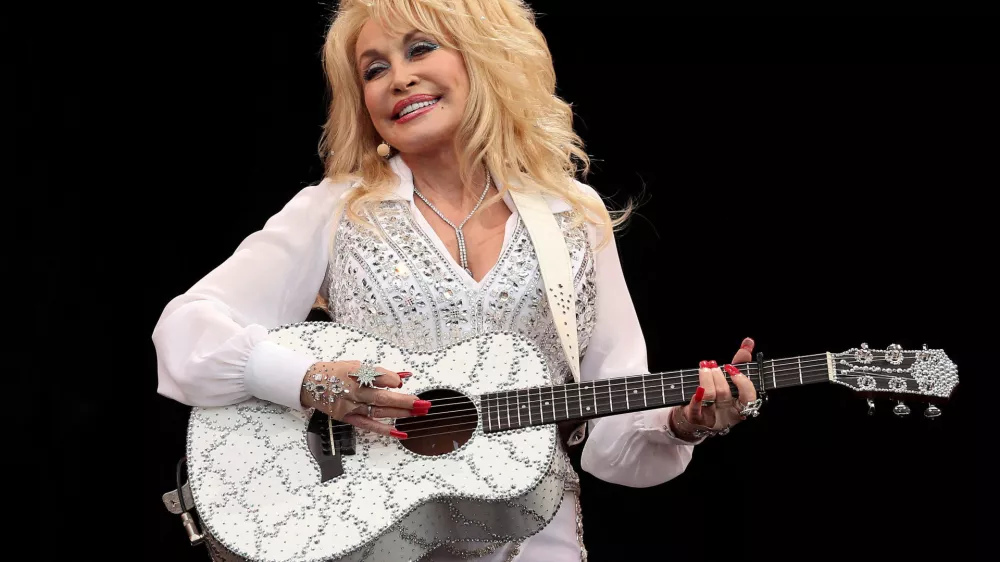 FILE PHOTO: American country music star Dolly Parton performs on the Pyramid Stage at Worthy Farm in Somerset, during the Glastonbury Festival June 29, 2014. REUTERS/Cathal McNaughton (BRITAIN - Tags: ENTERTAINMENT SOCIETY TPX IMAGES OF THE DAY)/File Photo