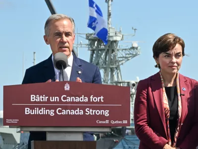 Canadian Prime Minister Mark Carney speaks as he announces a .3 billion contract for icebreakers at the Davie shipyard in Levis, Quebec on Monday, Aug. 24, 2026. Quebec Premier Christine Frechette, right, looks on. (Jacques Boissinot/The Canadian Press via AP)