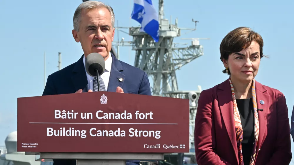 Canadian Prime Minister Mark Carney speaks as he announces a $11.3 billion contract for icebreakers at the Davie shipyard in Levis, Quebec on Monday, Aug. 24, 2026. Quebec Premier Christine Frechette, right, looks on. (Jacques Boissinot/The Canadian Press via AP)