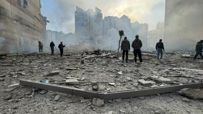 People stand on the rubble of a damaged building after an Israeli strike on Beirut's southern suburbs, following renewed hostilities between Hezbollah and Israel amid the U.S.-Israeli conflict with Iran, in Beirut, Lebanon, March 6, 2026. Picture taken with a mobile phone. REUTERS/Stringer