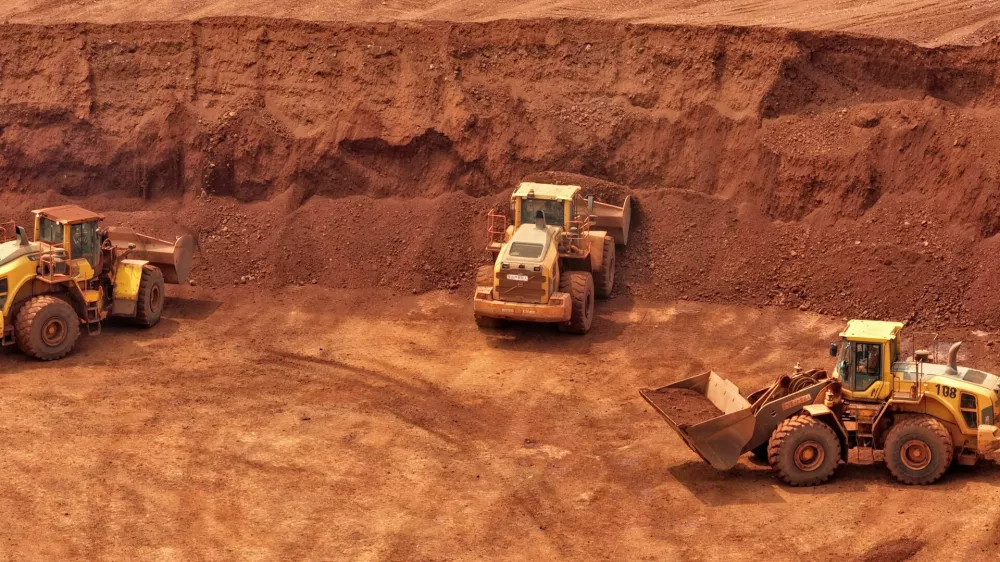 Loaders are filled with bauxite ore from Guinea at an ore yard in Yantai, Shandong, China, on June 18, 2026. (Photo by Costfoto/NurPhoto)NO USE FRANCE