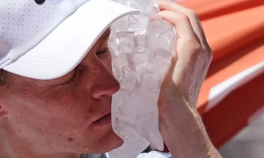 Jannik Sinner of Italy cools himself with the ice during the second round men's singles tennis match against Juan Manuel Cerundolo of Argentina at the French Open tennis tournament in Paris, Thursday, May 28, 2026. (AP Photo/Thibault Camus)