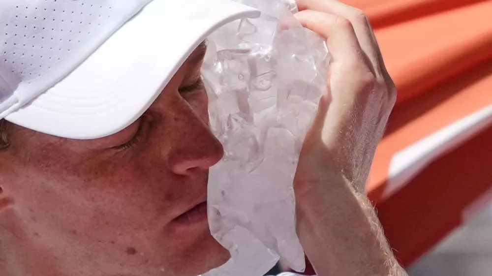 Jannik Sinner of Italy cools himself with the ice during the second round men's singles tennis match against Juan Manuel Cerundolo of Argentina at the French Open tennis tournament in Paris, Thursday, May 28, 2026. (AP Photo/Thibault Camus)