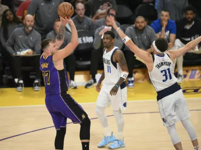 Los Angeles Lakers guard Luka Doncic (77) shoots over Dallas Mavericks guard Klay Thompson (31) during the second half of an NBA basketball game Tuesday, Feb. 25, 2025, in Los Angeles. (AP Photo/Kyusung Gong)