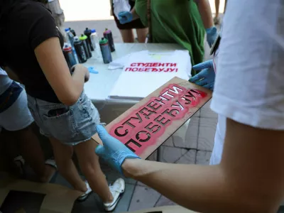 A volunteer carries a stencil with the slogan "Students are winning" to spray onto T-shirts as students gather during a protest as part of a nationwide anti-government movement triggered by the deadly collapse of the Novi Sad railway station canopy in November 2024, following Serbian President Aleksandar Vucic's resignation announcement, in Kraljevo, Serbia, June 28, 2026. REUTERS/Djordje Kojadinovic