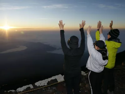 Climbers atop Mt. Fuji hail the sunrise on July 1, 2025, the day the mountain's Yoshida trail opened as the official climbing season began for Japan's highest mountain, straddling Shizuoka and Yamanashi prefectures.,Image: 1016624993, License: Rights-managed, Restrictions:, Model Release: no 
