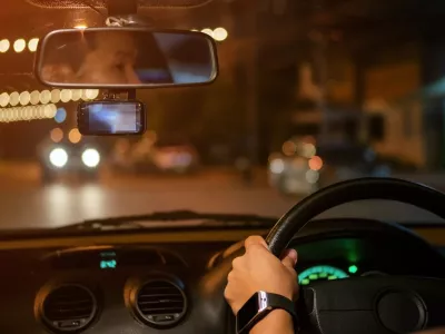Men driving a car at night.