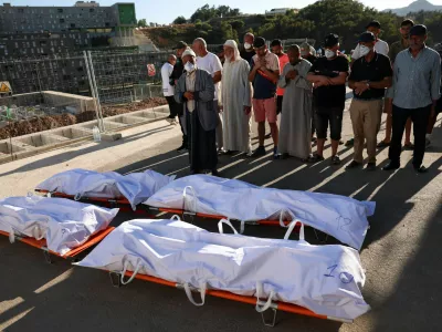 People pray during the funeral of migrants who died while trying to cross into Ceuta, at the city's Muslim cemetery, before burial in Ceuta, Spain, August 21, 2026. REUTERS/Violeta Santos Moura