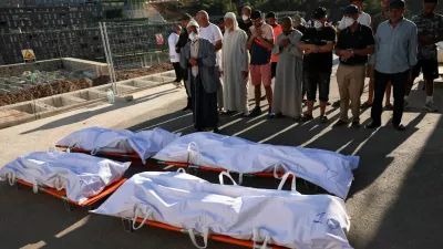 People pray during the funeral of migrants who died while trying to cross into Ceuta, at the city's Muslim cemetery, before burial in Ceuta, Spain, August 21, 2026. REUTERS/Violeta Santos Moura