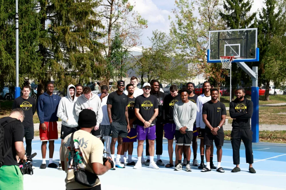 Basketball - NBA - Los Angeles Lakers visit to Ljubljana - Ljubljana, Slovenia - August 23, 2026 Los Angeles Lakers' Luka Doncic poses for a photo with teammates on the court where he played growing up in Ljubljana REUTERS/Borut Zivulovic
