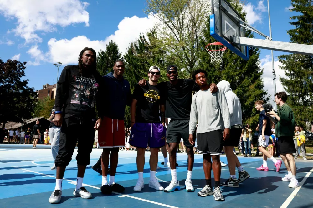 Basketball - NBA - Los Angeles Lakers visit to Ljubljana - Ljubljana, Slovenia - August 23, 2026 Los Angeles Lakers' Luka Doncic poses for a photo with teammates on the court where he played growing up in Ljubljana REUTERS/Borut Zivulovic