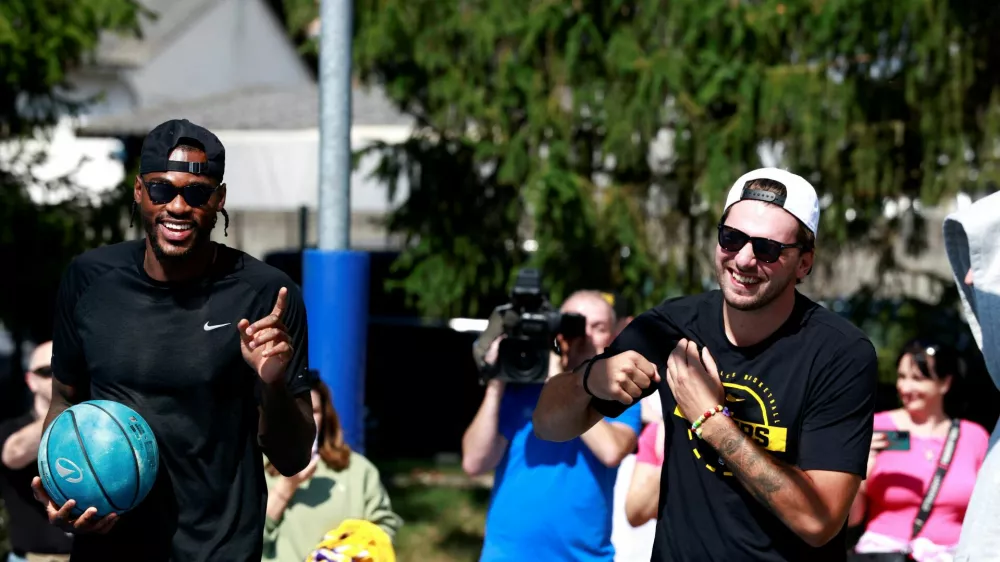 Basketball - NBA - Los Angeles Lakers visit to Ljubljana - Ljubljana, Slovenia - August 23, 2026 Los Angeles Lakers' Luka Doncic with Jarred Vanderbilt on the court where he played growing up in Ljubljana REUTERS/Borut Zivulovic