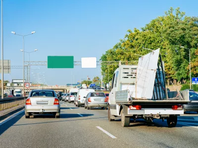 Car carrying trailer in the asphalt road of Slovenia.