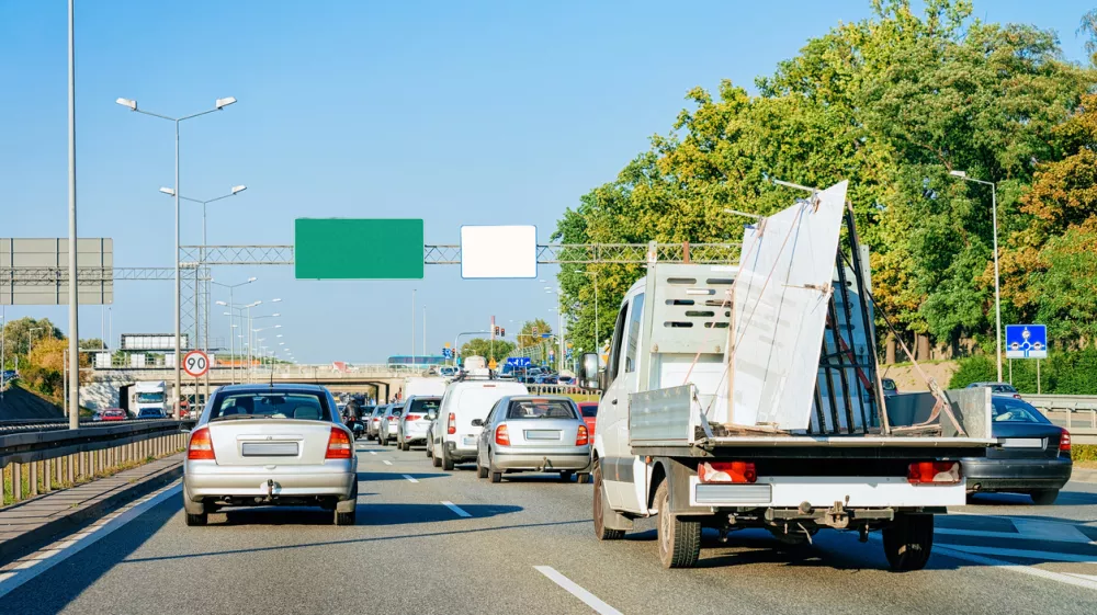 Car carrying trailer in the asphalt road of Slovenia.