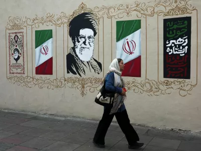 A woman walks by a mural depicting Iran's late Supreme Leader Ayatollah Ali Khamenei, on a street in Tehran, Iran, August 13, 2026. Majid Asgaripour/WANA (West Asia News Agency) via REUTERS ATTENTION EDITORS - THIS PICTURE WAS PROVIDED BY A THIRD PARTY. ISRAEL OUT. NO COMMERCIAL OR EDITORIAL SALES IN ISRAEL. NO ACCESS FOR ISRAELI MEDIA. NO USE BBC PERSIAN. NO USE VOA PERSIAN. NO USE MANOTO. NO USE IRAN INTERNATIONAL. NO USE RADIO FARDA. DIGITAL: NO USE BBC PERSIAN. NO USE VOA PERSIAN. NO USE MANOTO. NO USE IRAN INTERNATIONAL. NO USE RADIO FARDA.