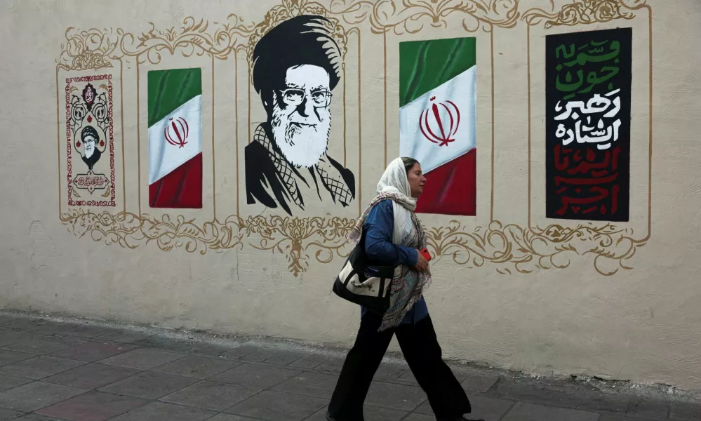 A woman walks by a mural depicting Iran's late Supreme Leader Ayatollah Ali Khamenei, on a street in Tehran, Iran, August 13, 2026. Majid Asgaripour/WANA (West Asia News Agency) via REUTERS ATTENTION EDITORS - THIS PICTURE WAS PROVIDED BY A THIRD PARTY. ISRAEL OUT. NO COMMERCIAL OR EDITORIAL SALES IN ISRAEL. NO ACCESS FOR ISRAELI MEDIA. NO USE BBC PERSIAN. NO USE VOA PERSIAN. NO USE MANOTO. NO USE IRAN INTERNATIONAL. NO USE RADIO FARDA. DIGITAL: NO USE BBC PERSIAN. NO USE VOA PERSIAN. NO USE MANOTO. NO USE IRAN INTERNATIONAL. NO USE RADIO FARDA.