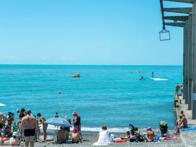 Sochi, Russia - July 05 2022: City beach on the seashore with sun loungers and umbrellas. Beach with vacationing tourists on the seashore on a sunny day.,Image: 1070798235, License: Royalty-free, Restrictions:, Model Release: no 