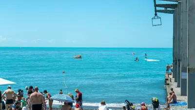 Sochi, Russia - July 05 2022: City beach on the seashore with sun loungers and umbrellas. Beach with vacationing tourists on the seashore on a sunny day.,Image: 1070798235, License: Royalty-free, Restrictions:, Model Release: no 