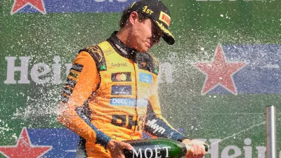 McLaren driver Lando Norris of Britain sprays champagne after winning the Formula One Dutch Grand Prix in Zandvoort, Netherlands, Sunday, Aug. 23, 2026. (AP Photo/Patrick Post)