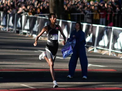 Ethiopian long-distance runner Yomif Kejelcha crosses the finish line to win the Buenos Aires 21K race in Buenos Aires, Argentina, Sunday, Aug. 23, 2026. (AP Photo/Natacha Pisarenko)