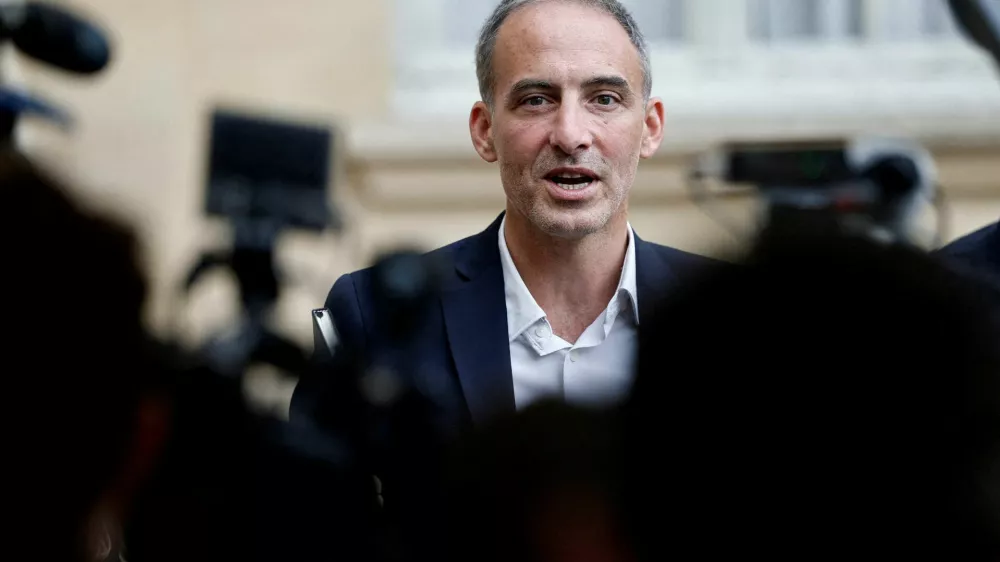 FILE PHOTO: Raphael Glucksmann, MEP and co-president of the political movement "Place Publique", talks to journalists as he leaves after a meeting with the French Prime Minister as part of a series of consultations with political parties, a week before a confidence vote he is seeking from the National Assembly on the budget issue, at the Hotel Matignon in Paris, France, September 2, 2025. REUTERS/Benoit Tessier/File Photo