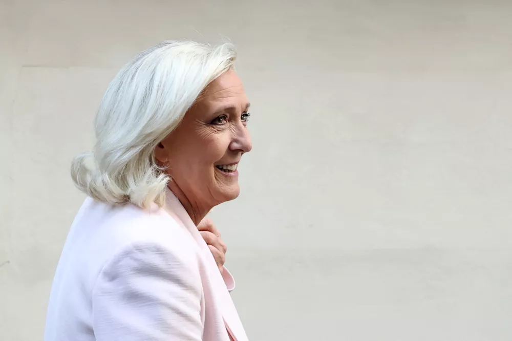 French far-right leader Marine Le Pen, member of parliament for the Rassemblement National (National Rally - RN) party, leaves after a party meeting at the Rassemblement National headquarters following the verdict in her appeal trial, alongside the RN party itself and 10 others defendants found guilty of diverting European Parliament funds, in Paris, France, July 7, 2026. REUTERS/Stephane Mahe    TPX IMAGES OF THE DAY