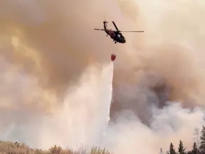 A Nevada National Guard helicopter drops water on the Hawk Fire, as the wildfire burns, in Reno, Nevada, U.S., August 23, 2026, in this still image taken from video.  Nevada National Guard/Handout via REUTERS  THIS IMAGE HAS BEEN SUPPLIED BY A THIRD PARTY. NO RESALES. NO ARCHIVES. MANDATORY CREDIT