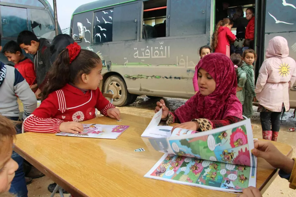 The-childrens-joy-when-the-third-bus-visited-their-camp-north-of-Idlib-1-scaled- The-childrens-joy-when-the-third-bus-visited-their-camp-north-of-Idlib-1-scaled-