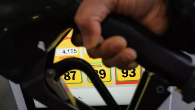 A person fills up her vehicle's gas tank at a gas station in Buffalo Grove, Ill., Thursday, April 2, 2026. (AP Photo/Nam Y. Huh)