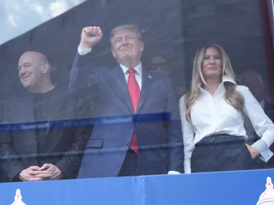 President Donald Trump, first lady Melania Trump and Dana White watch after Kyle Kirkwood (27) won the IndyCar Freedom 250 Grand Prix auto race in Washington, Sunday, Aug. 23, 2026. (AP Photo/Alex Brandon)