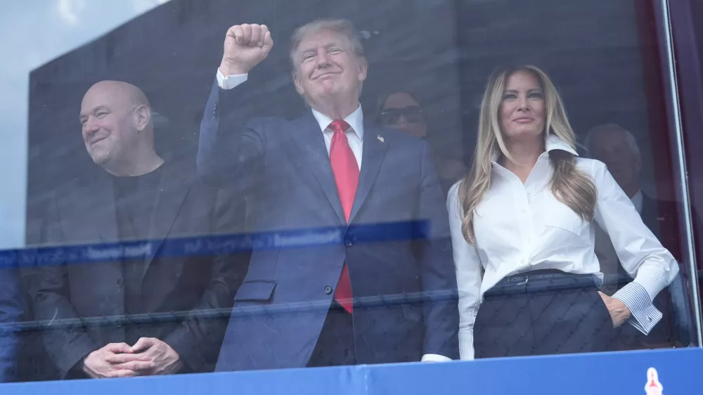 President Donald Trump, first lady Melania Trump and Dana White watch after Kyle Kirkwood (27) won the IndyCar Freedom 250 Grand Prix auto race in Washington, Sunday, Aug. 23, 2026. (AP Photo/Alex Brandon)