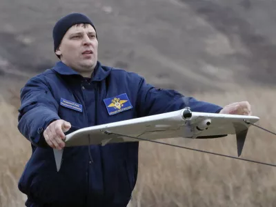 A police officer launches a Russian-made drone, an unmanned aerial vehicle (UAV), "Zala-42180", using a catapult, near the Siberian city of Krasnoyarsk, October 28, 2010. According to the police, the new drones will be used to help them monitor the district, search for people, detect forest fires, and other tasks. REUTERS/Ilya Naymushin (RUSSIA - Tags: SCI TECH TRANSPORT)