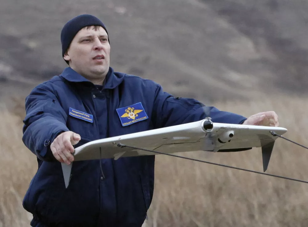 A police officer launches a Russian-made drone, an unmanned aerial vehicle (UAV), "Zala-42180", using a catapult, near the Siberian city of Krasnoyarsk, October 28, 2010. According to the police, the new drones will be used to help them monitor the district, search for people, detect forest fires, and other tasks. REUTERS/Ilya Naymushin (RUSSIA - Tags: SCI TECH TRANSPORT)