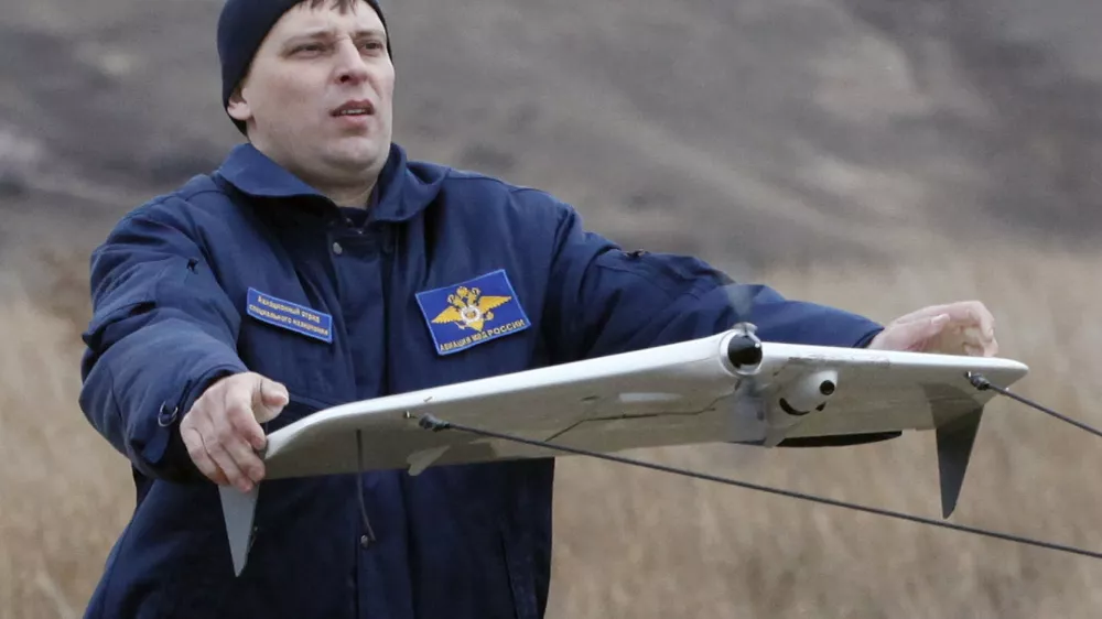 A police officer launches a Russian-made drone, an unmanned aerial vehicle (UAV), "Zala-42180", using a catapult, near the Siberian city of Krasnoyarsk, October 28, 2010. According to the police, the new drones will be used to help them monitor the district, search for people, detect forest fires, and other tasks. REUTERS/Ilya Naymushin (RUSSIA - Tags: SCI TECH TRANSPORT)