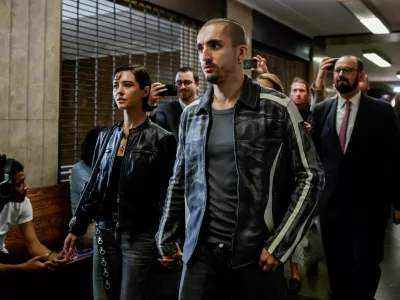 Angela Nikolau and Ivan Kuznetsov, who climbed the Empire State Building, leave court in New York City, U.S., August 24, 2026. REUTERS/Jeenah Moon