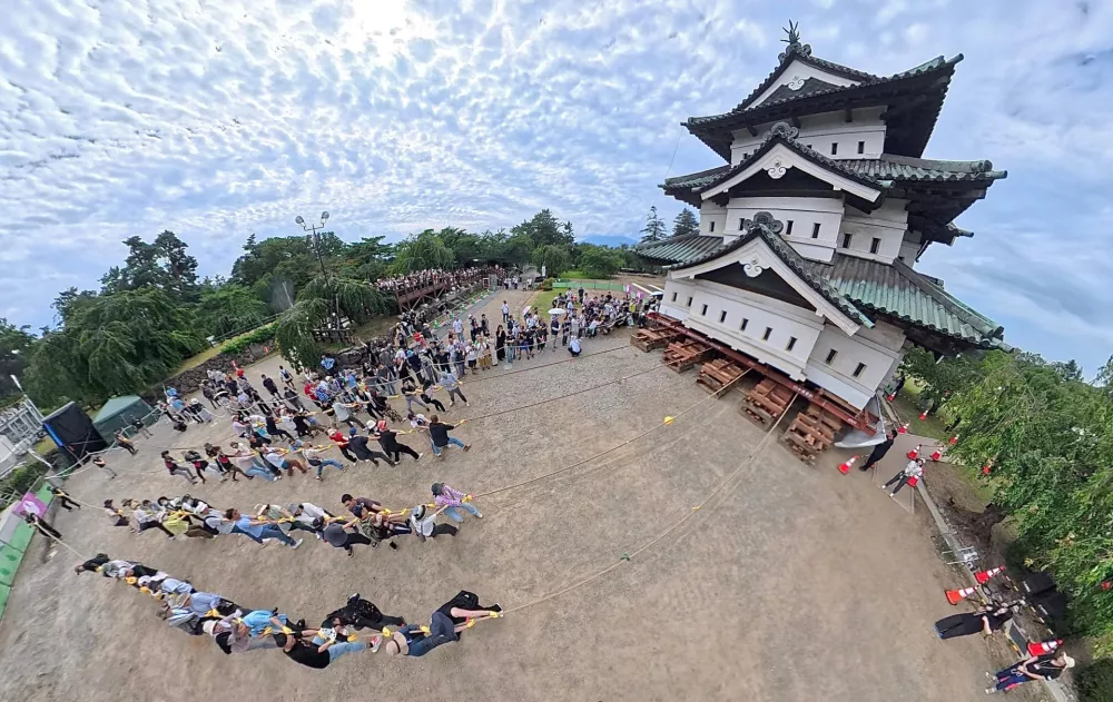 Participants pull the castle tower of Hirosaki Castle during the Hikimodoshi event in Hirosaki City, Aomori Prefecture, on August 23, 2026.　Hikimodoshi is the project to pull the castle tower back onto its original foundation. Hikimodoshi at the Hirosaki Castle Ruins, a National Historic Site, is being held for the first time in 111 years. (The Yomiuri Shimbun)