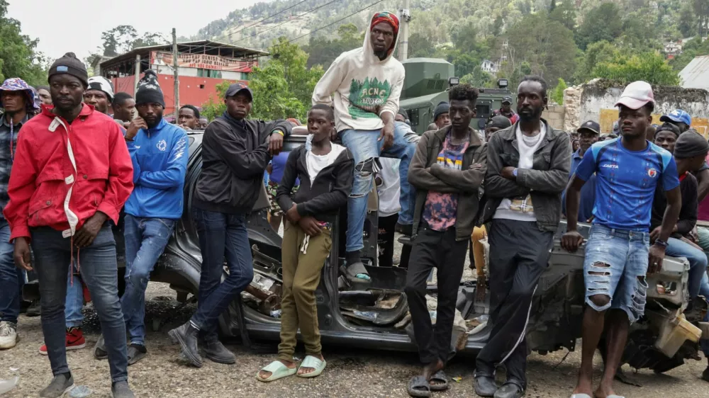 Residents gather during a protest against insecurity after a fatal overnight raid by an armed gang, on the outskirts of Port-au-Prince, in Kenscoff, Haiti, August 24, 2026. REUTERS/Fildor Pq Egeder