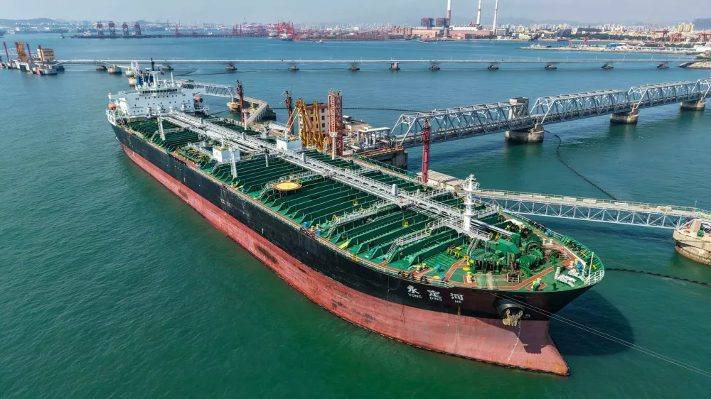 A cargo ship unloads imported crude oil at the oil terminal of Qingdao Port in Qingdao, east China's Shandong province, July 30, 2026.No Use China. No Use France.