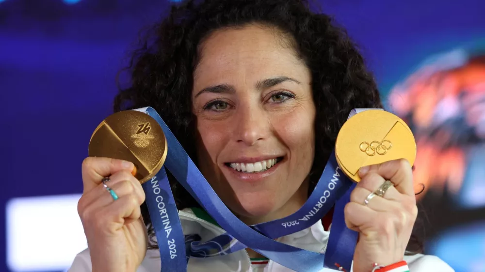 Italy's alpine skier Federica Brignone shows her two gold medals after a press conference in Cortina d'Ampezzo, Italy, February 16, 2026. REUTERS/Leonhard Foeger