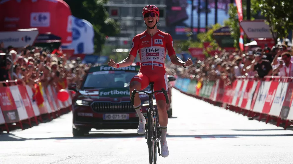 Cycling - Vuelta a Espana - Stage 4 - Andorra la Vella to Andorra la Vella - Andorra la Vella, Andorra - August 25, 2026 UAE Team Emirates - XRG's Tadej Pogacar celebrates as he crosses the line to win stage 4 REUTERS/Bruna Casas