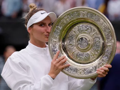 FILE PHOTO: Tennis - Wimbledon - All England Lawn Tennis and Croquet Club, London, Britain - July 15, 2023 Czech Republic's Marketa Vondrousova celebrates with the trophy winning her final match against Tunisia's Ons Jabeur REUTERS/Andrew Couldridge/File Photo
