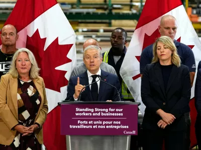 Minister of Finance and National Revenue Francois-Philippe Champagne speaks at a news conference on Canada's response to U.S. tariffs, at a roofing company in Ottawa, on Tuesday, Aug. 25, 2026. (Justin Tang/The Canadian Press via AP)