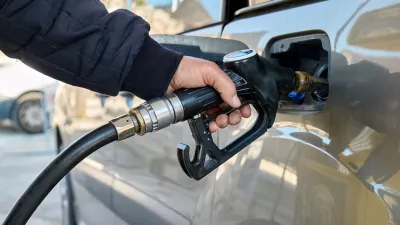 Hand of man driver holding fuel pump and refilling gasoline tank of car with fuel at gas station.