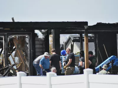 Investigators work at the scene Tuesday, Aug. 25, 2026, where a family was killed and the house burned in Billings, Mont. (AP Photo/Matthew Brown)