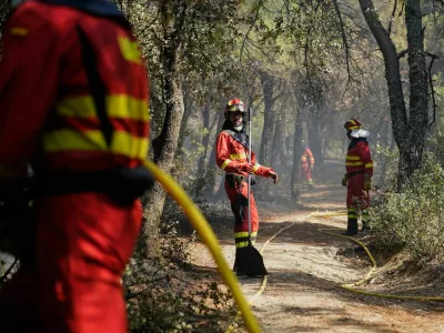 Members of the Military Emergencies Unit (UME) refresh the area after putting out a fire in San Martin de Valdeiglesias, Madrid, Spain July 26, 2026. REUTERS/Ana Beltran